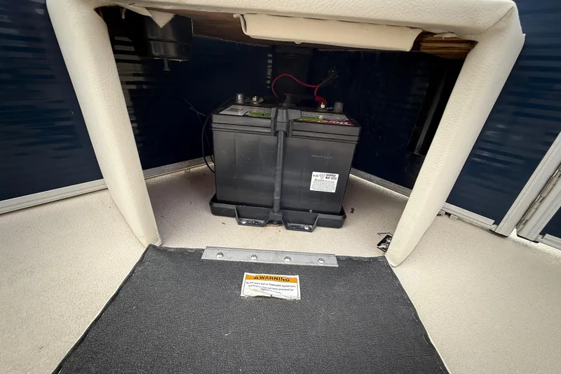 Slide: The Image of 2018 Sweetwater Sunrise 206 F boat interior with open storage compartment and seating. - 71