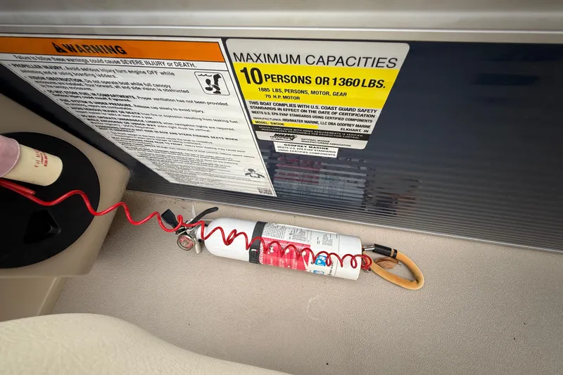 Slide: The Image of 2018 Sweetwater Sunrise 206 F boat capacity warning label and fire extinguisher. - 78