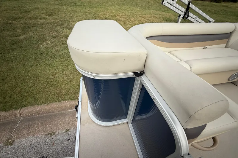 Slide: The Image of 2018 Sweetwater Sunrise 206 F pontoon boat with beige seating and blue paneling. - 90