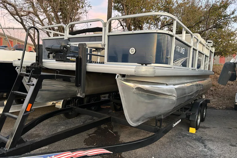 Slide: The Image of 2018 Sweetwater Sunrise 206 F pontoon boat on trailer, parked outdoors. - 93