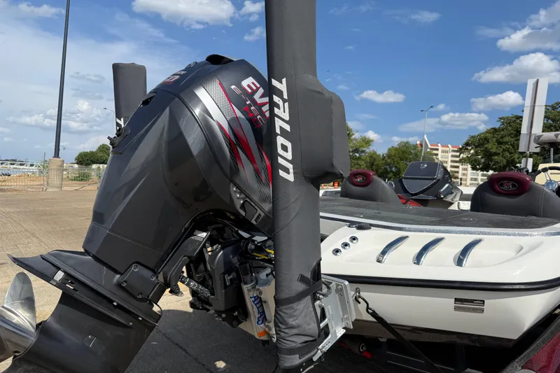 Slide: The Image of 2014 Ranger Z520 Comanche boat with Evinrude engine on trailer, parked outdoors. - 11