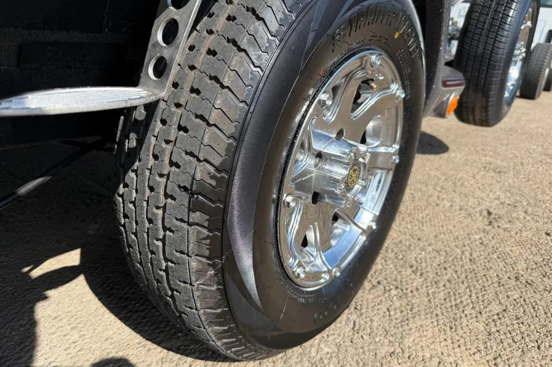 Slide: The Image of 2014 Ranger Z520 Comanche boat on trailer by a lake under a cloudy sky. - 18