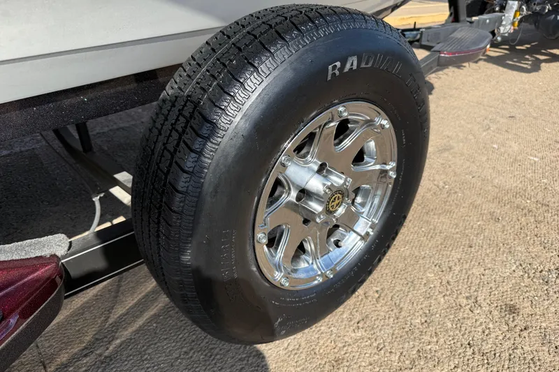 Slide: The Image of 2014 Ranger Z520 Comanche boat on trailer by a lakeside dock. - 19