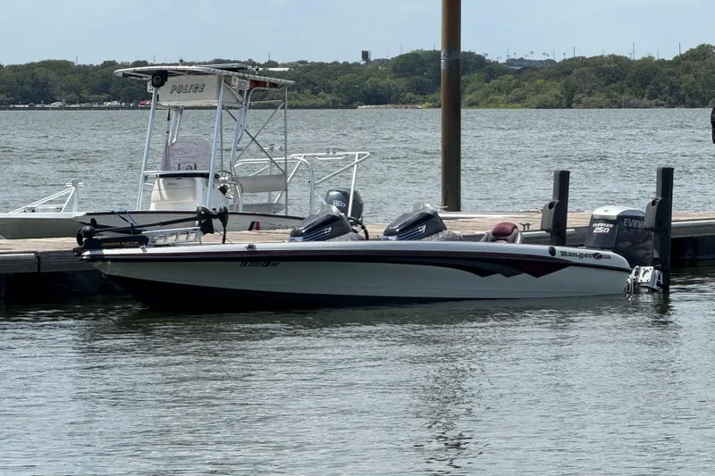 Slide: The Image of 2014 Ranger Z520 Comanche boat on trailer by a lake under a cloudy sky. - 2
