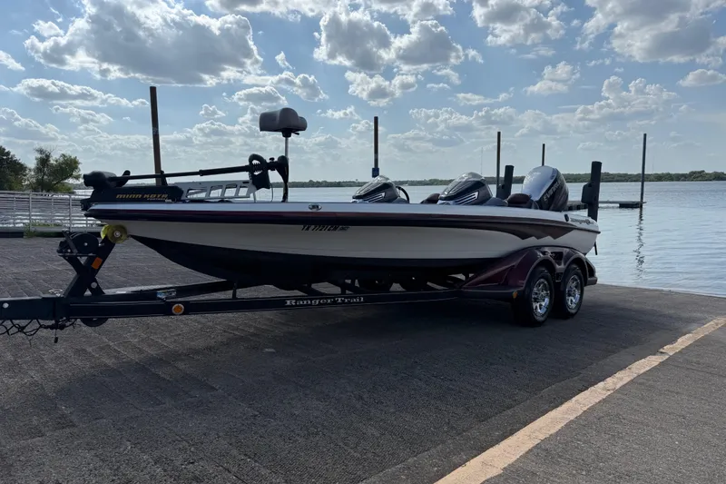 Slide: The Image of 2014 Ranger Z520 Comanche boat on trailer, parked outdoors under a clear sky. - 20