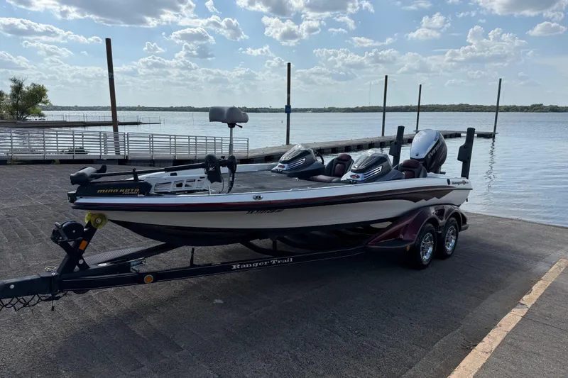 Slide: The Image of 2014 Ranger Z520 Comanche boat on trailer, parked outdoors under a clear sky. - 21