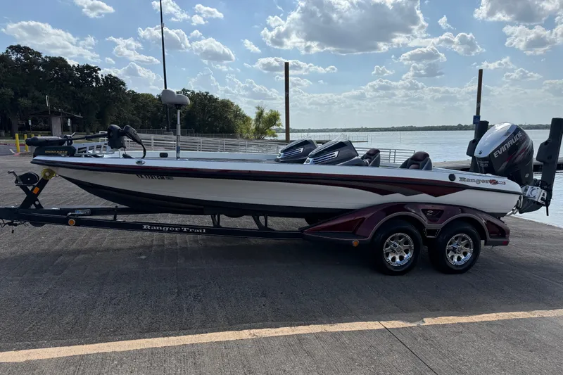 Slide: The Image of 2014 Ranger Z520 Comanche boat with powerful outboard motor, parked outdoors. - 23