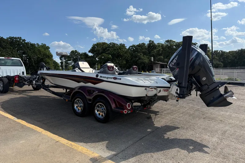 Slide: The Image of 2014 Ranger Z520 Comanche boat trailer with shiny chrome wheels on a sunny day. - 27