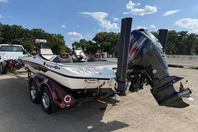 Slide: The Image of 2014 Ranger Z520 Comanche boat trailer with shiny chrome wheels on a sunny day. - 28