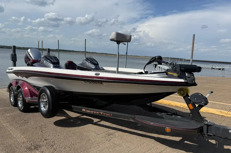 Slide: The Image of 2014 Ranger Z520 C boat docked on a calm lake with a police boat nearby. - 3