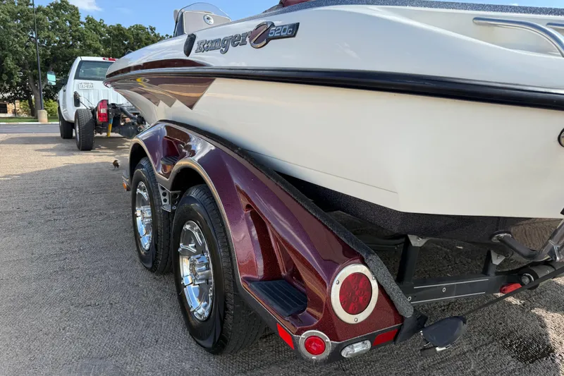Slide: The Image of Close-up of 2014 Ranger Z520 Comanche trailer tire and chrome wheel on pavement. - 34