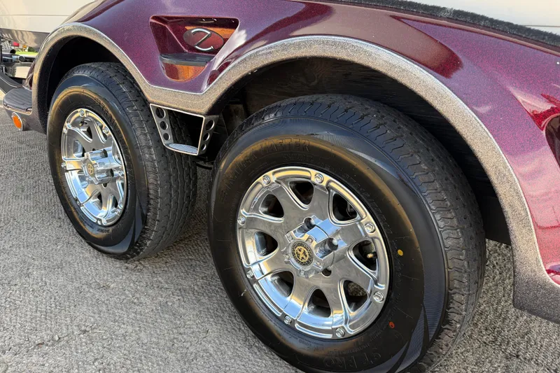 Slide: The Image of Close-up of 2014 Ranger Z520 Comanche trailer wheels on concrete surface. - 36
