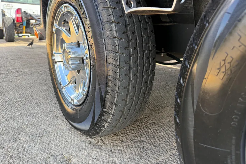 Slide: The Image of 2014 Ranger Z520 Comanche boat docked by a serene lake under a cloudy sky. - 38