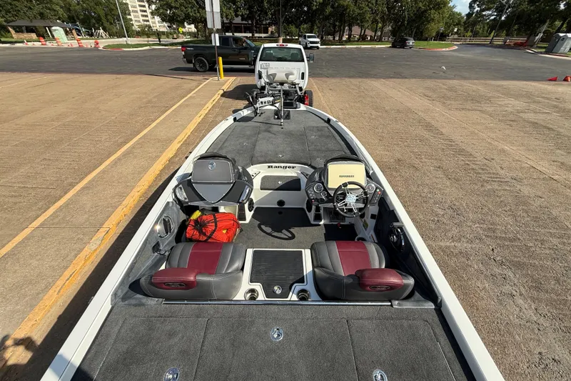 Slide: The Image of 2014 Ranger Z520 Comanche boat with open storage compartment and fishing rod holder. - 42