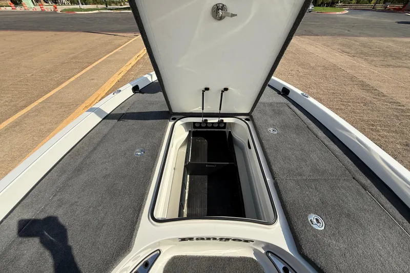 Slide: The Image of Open storage compartment on 2014 Ranger Z520 Comanche boat, featuring carpeted interior. - 43