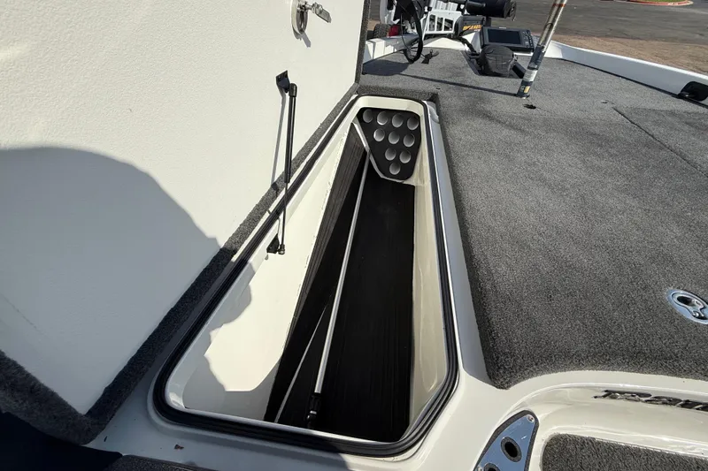 Slide: The Image of 2014 Ranger Z520 Comanche boat storage compartment with open lid and visible speakers. - 44