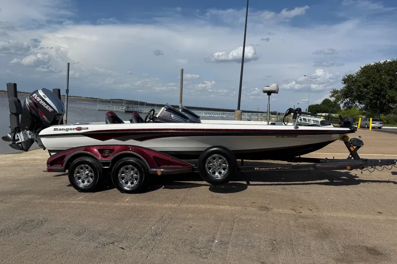 Slide: The Image of 2014 Ranger Z520 Comanche boat on trailer by a lake under cloudy sky. - 5