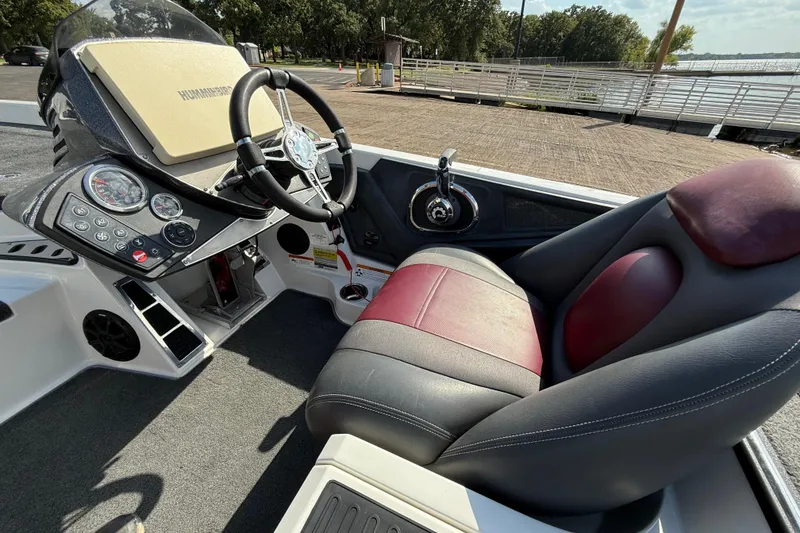 Slide: The Image of 2014 Ranger Z520 Comanche boat dashboard with Humminbird display and steering wheel. - 52