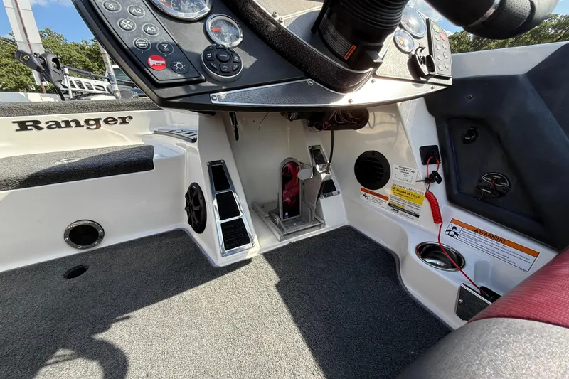Slide: The Image of 2014 Ranger Z520 Comanche boat at a lakeside dock, featuring dual seats and a powerful engine. - 53