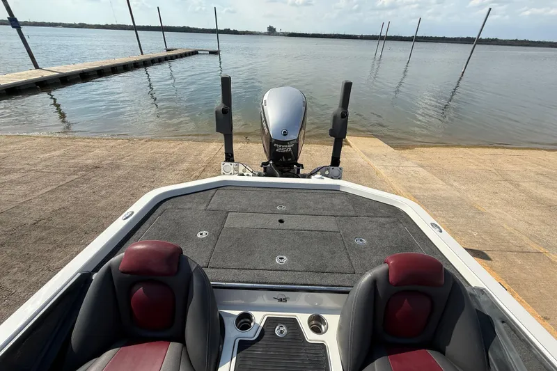 Slide: The Image of Storage compartment of 2014 Ranger Z520 Comanche boat, featuring carpeted interior and hydraulic lift. - 55