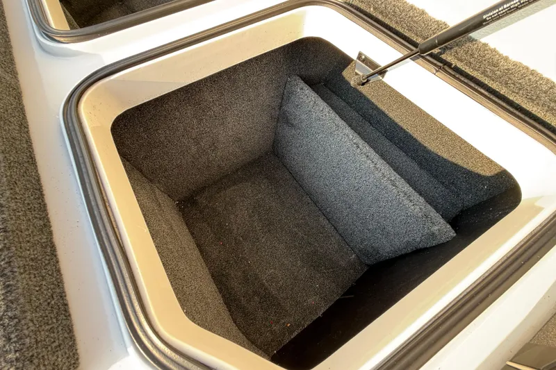 Slide: The Image of 2014 Ranger Z520 Comanche boat storage compartment with latch and carpeted flooring. - 57