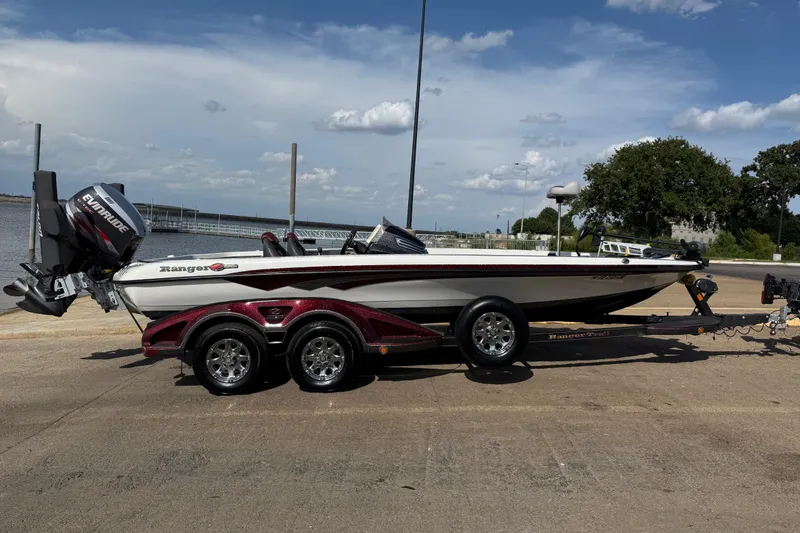 Slide: The Image of 2014 Ranger Z520 Comanche boat on trailer by a lake under a cloudy sky. - 6