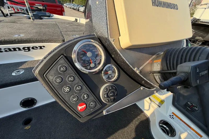 Slide: The Image of Steering wheel and dashboard of 2014 Ranger Z520 Comanche boat, featuring control panel and gauges. - 63
