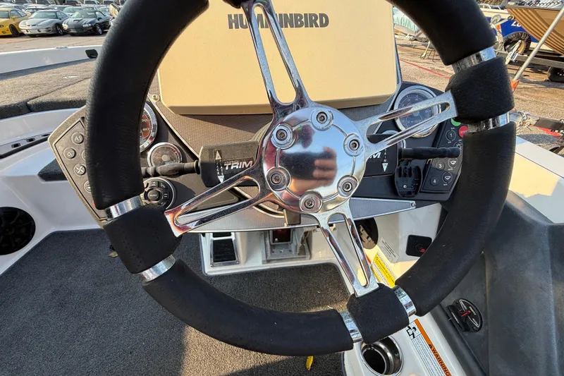 Slide: The Image of 2014 Ranger Z520 Comanche boat deck with motor, parked outdoors. - 64