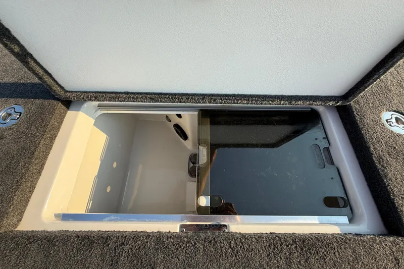 Slide: The Image of Open storage compartment on 2014 Ranger Z520 Comanche boat, featuring carpeted interior. - 67