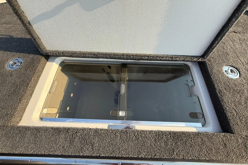 Slide: The Image of Open storage compartment in 2014 Ranger Z520 Comanche boat with a battery charger inside. - 69