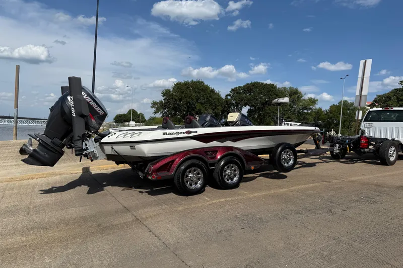 Slide: The Image of 2014 Ranger Z520 Comanche boat on trailer by a lakeside dock. - 8