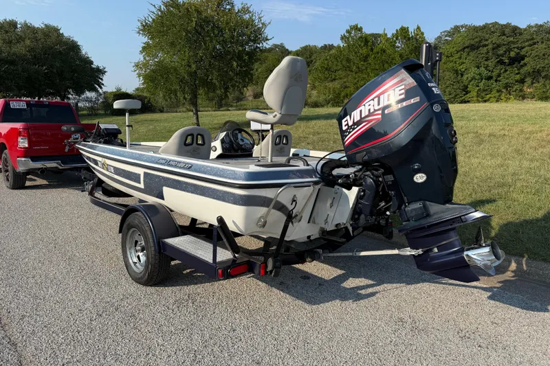 Slide: The Image of 2008 Bee Line 286 Pro Vee boat with Evinrude motor on trailer, parked outdoors. - 10