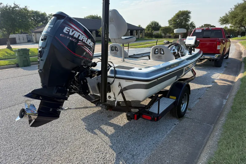 Slide: The Image of 2008 Bee Line 286 Pro Vee boat with Evinrude engine on trailer, parked on street. - 12