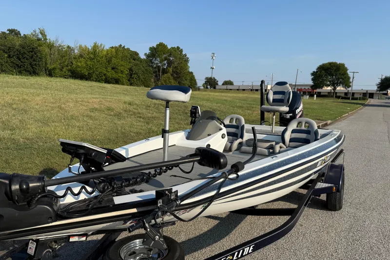 Slide: The Image of 2008 Bee Line 286 Pro Vee boat on trailer, parked on a road near grassy area. - 20