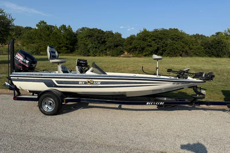 Slide: The Image of 2008 Bee Line 286 Pro Vee boat on trailer, parked on roadside with grassy background. - 24