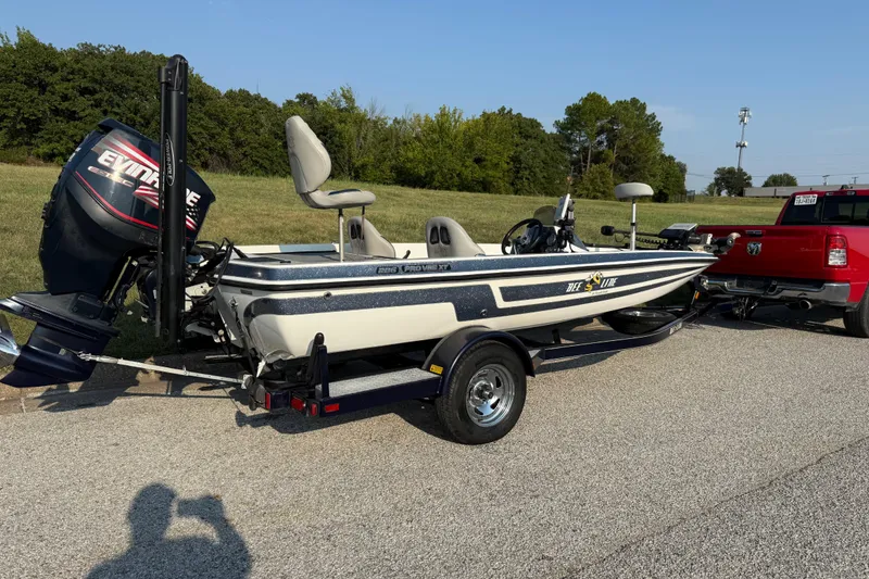 Slide: The Image of 2008 Bee Line 286 Pro Vee boat on trailer, attached to red truck, parked outdoors. - 27