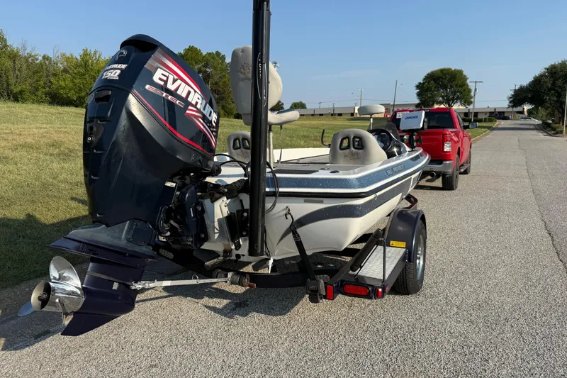 Slide: The Image of 2008 Bee Line 286 Pro Vee boat with Evinrude motor, hitched to a red truck. - 29