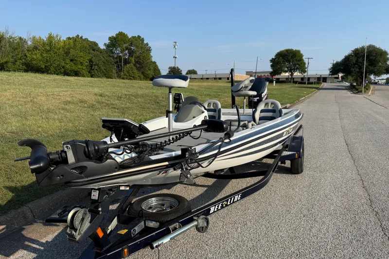 Slide: The Image of 2008 Bee Line 286 Pro Vee boat on trailer, parked on a road near grassy area. - 3