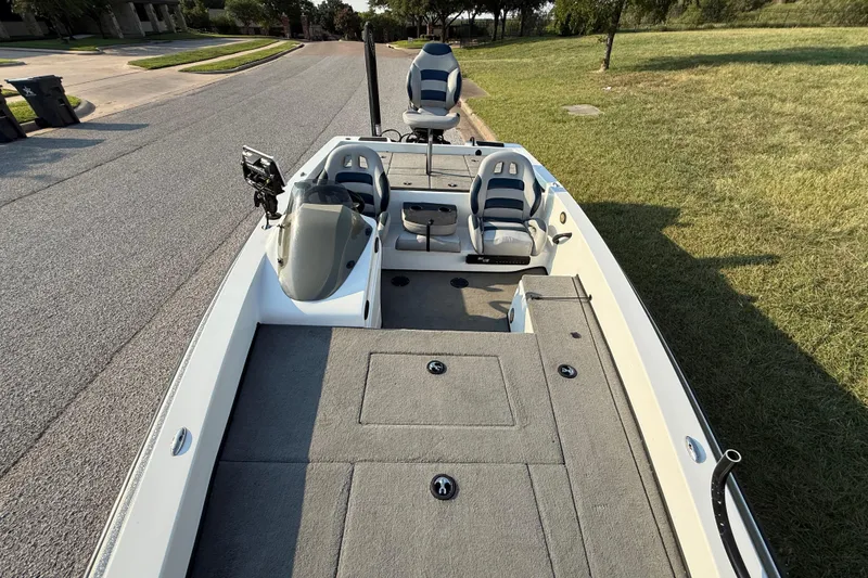 Slide: The Image of 2008 Bee Line 286 Pro Vee boat with seating and storage, parked on a street. - 32