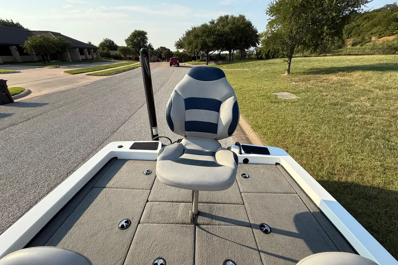Slide: The Image of 2008 Bee Line 286 Pro Vee boat with cushioned seat on a sunny street. - 44