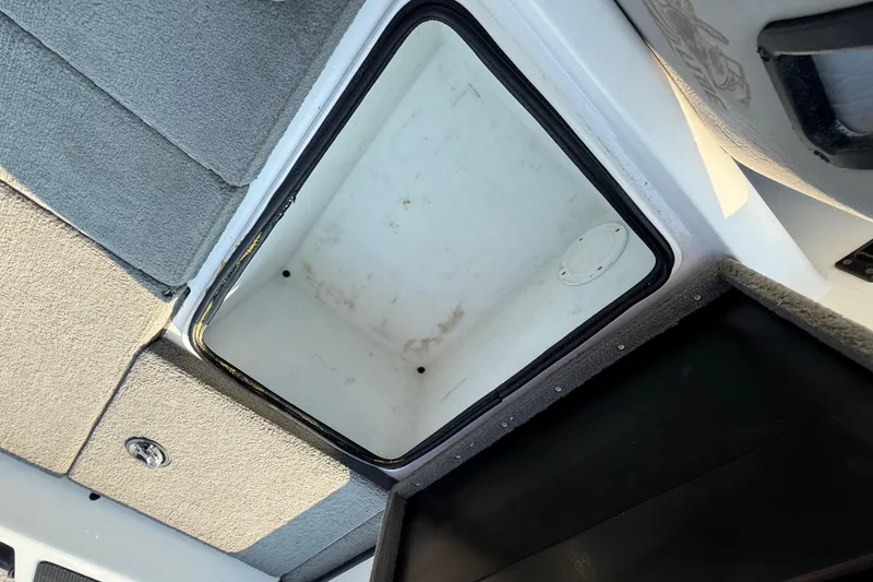 Slide: The Image of Open storage compartment in 2008 Bee Line 286 Pro Vee boat interior. - 45