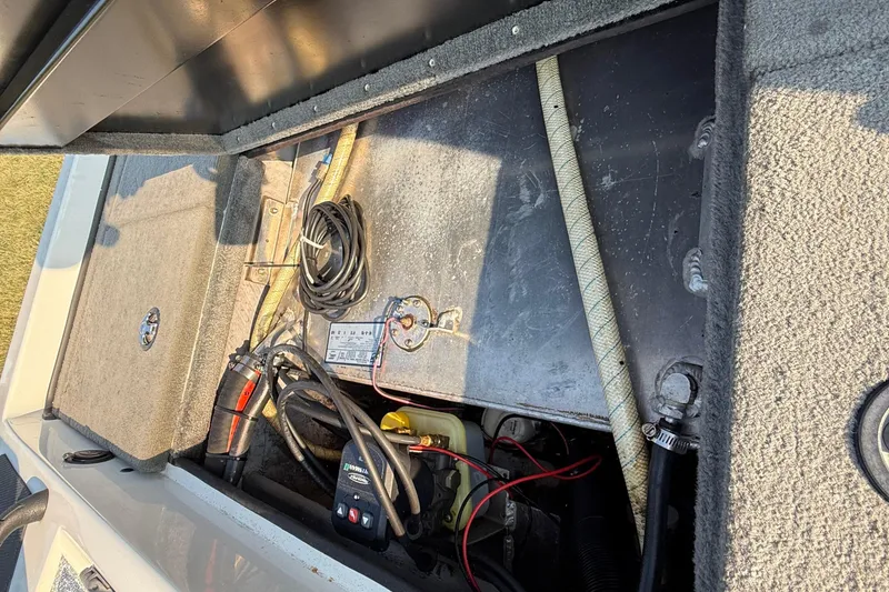 Slide: The Image of Open storage compartment of 2008 Bee Line 286 Pro Vee boat with wiring and equipment. - 47