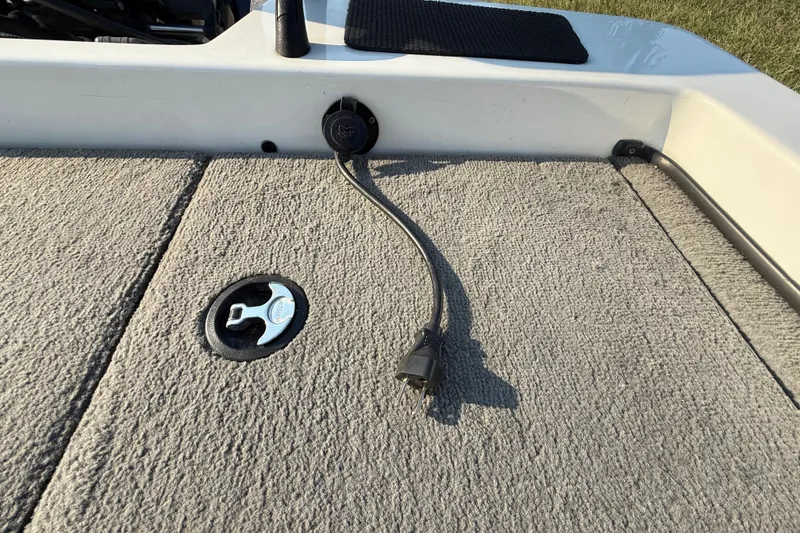 Slide: The Image of 2008 Bee Line 286 Pro Vee boat deck with power outlet and plug. - 49
