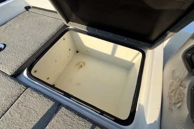 Slide: The Image of Open storage compartment in 2008 Bee Line 286 Pro Vee boat, showing interior details. - 51
