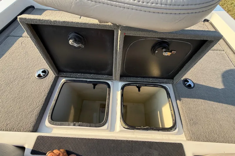 Slide: The Image of 2008 Bee Line 286 Pro Vee boat storage compartments with open lids. - 52