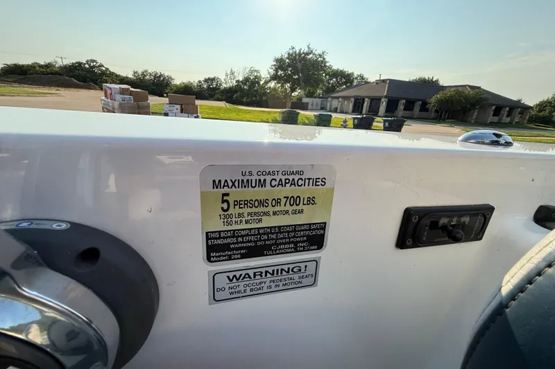 Slide: The Image of 2008 Bee Line 286 Pro Vee boat capacity label, 5 persons or 700 lbs limit. - 55