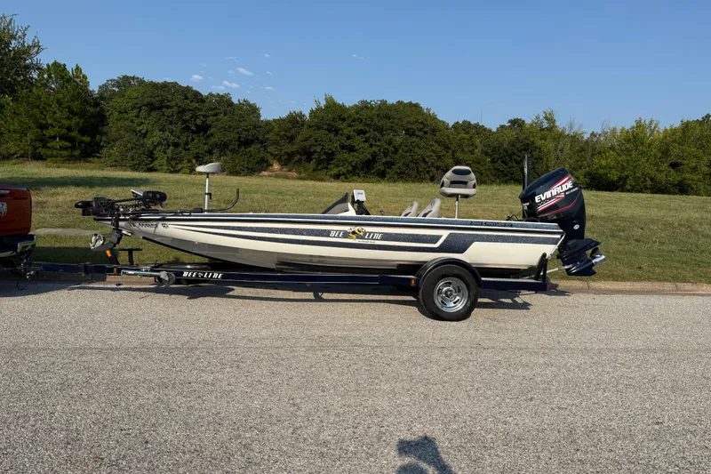 Slide: The Image of 2008 Bee Line 286 Pro Vee boat on trailer, parked on a road with grassy background. - 7