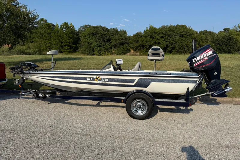 Slide: The Image of 2008 Bee Line 286 Pro Vee boat with Evinrude motor on trailer, parked outdoors. - 8