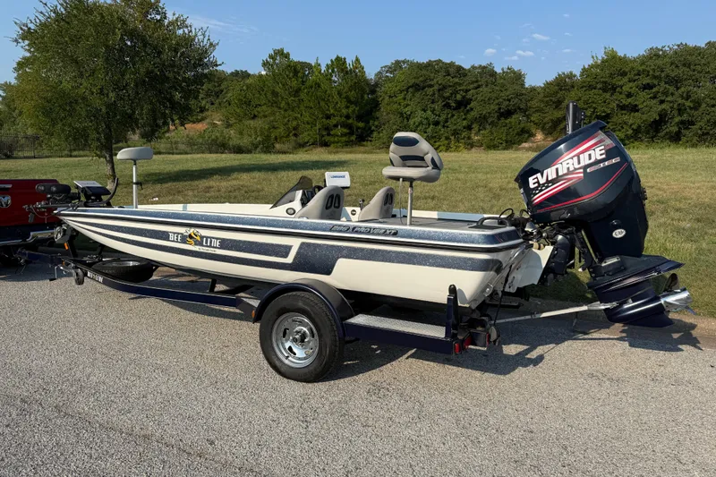 Slide: The Image of 2008 Bee Line 286 Pro Vee boat with Evinrude motor on trailer, parked outdoors. - 9