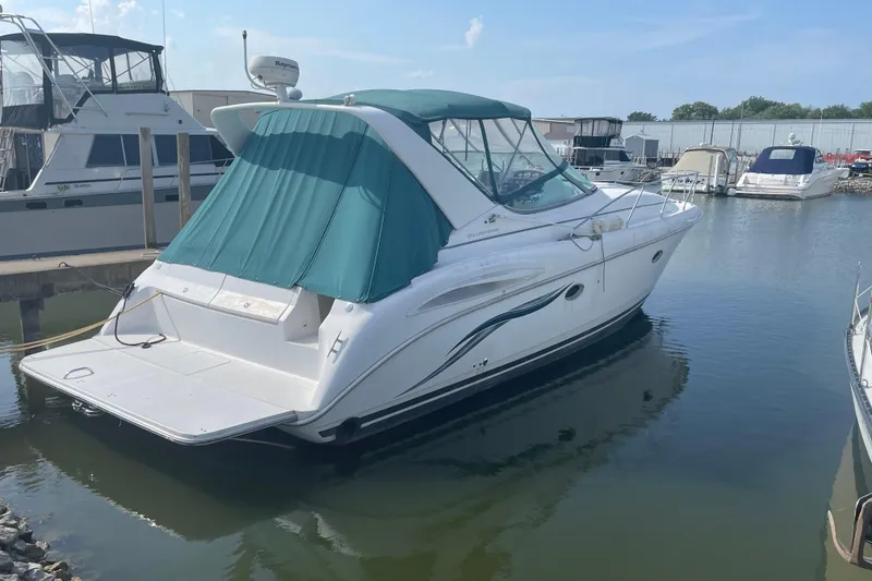 The Image of 1999 Silverton 360 Express yacht docked in marina, featuring green canopy. - 0
